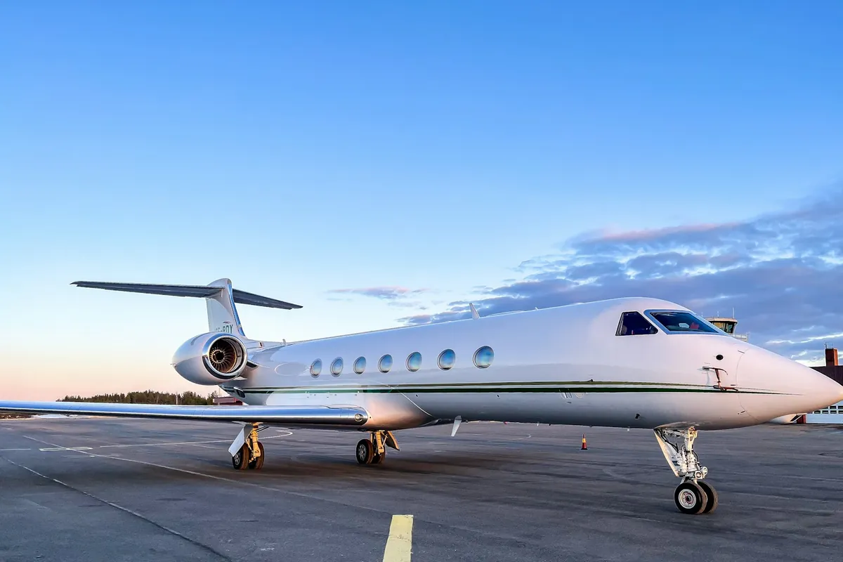 Gulfstream parked on a ramp under a blue sky